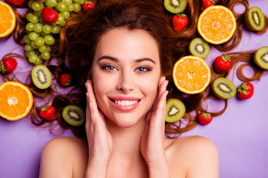 Girl lying with fruits in the background in summer to keep skin hydrated